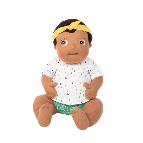Rubens Barn baby doll Flo with yellow headband, dotted shirt and green nappy pants, sitting