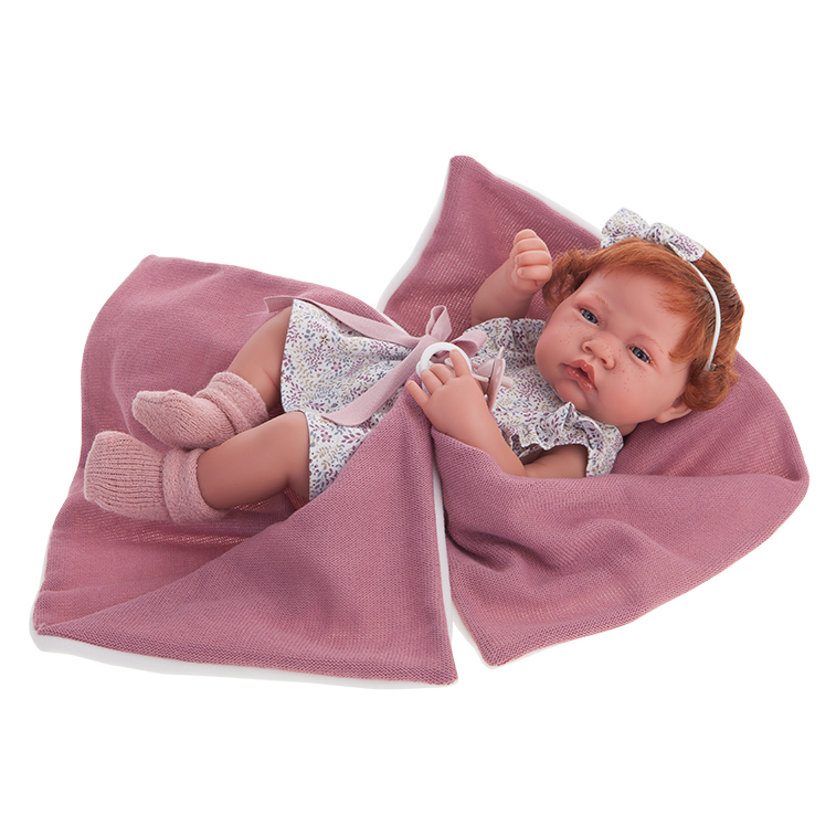 Antonio Juan baby doll New Born, realistic doll with red hair in a floral dress, wrapped in a dusty pink cuddly blanket