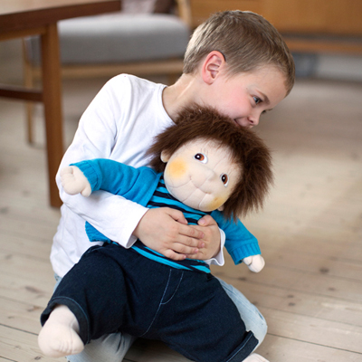 Child hugging the Rubens Barn Original doll Emil