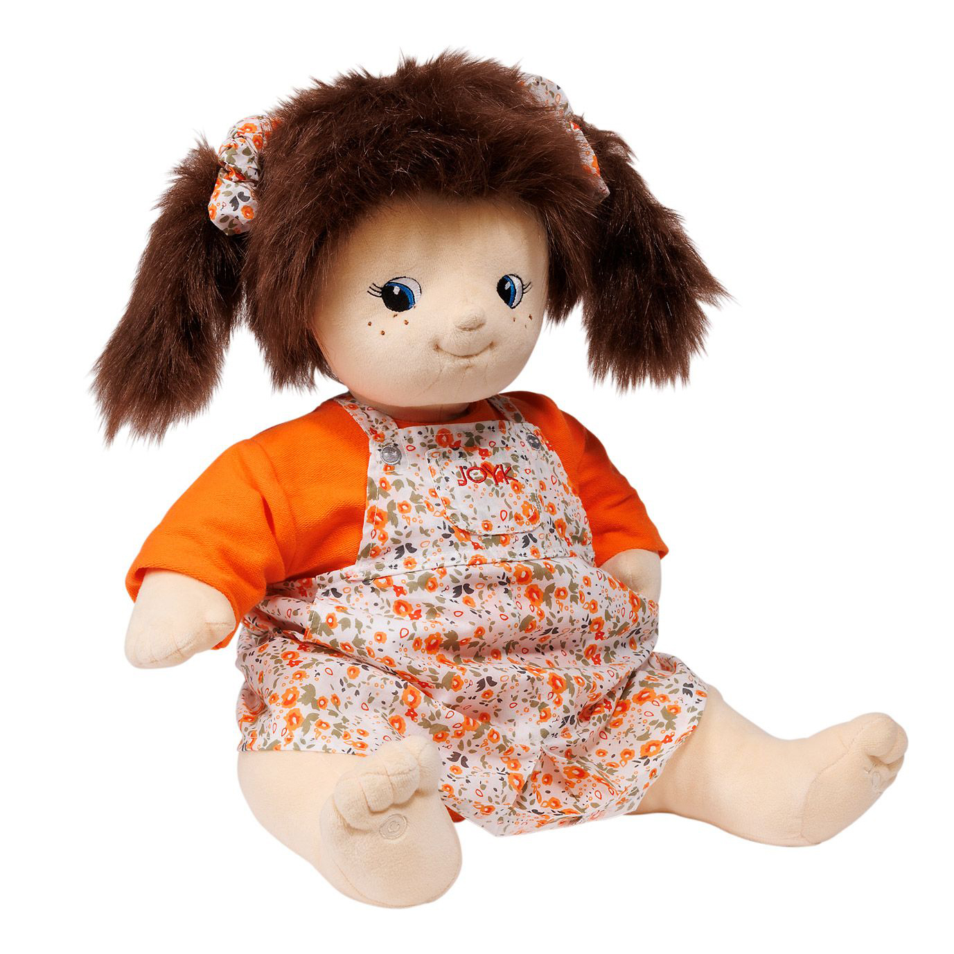 Joyk empathy doll Simone sitting with freckles and a floral bib romper